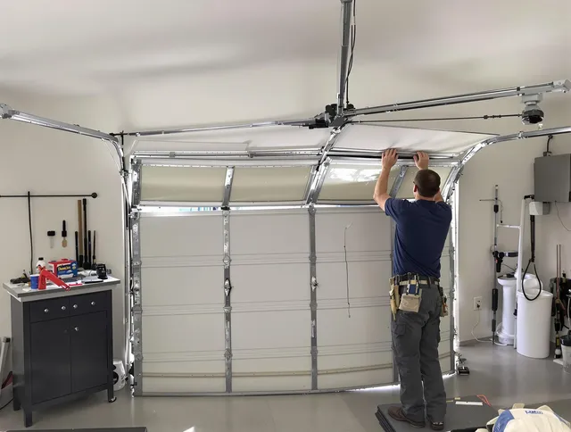 East Lyme Garage Door Repair specialist performing precise section replacement on East Lyme garage door